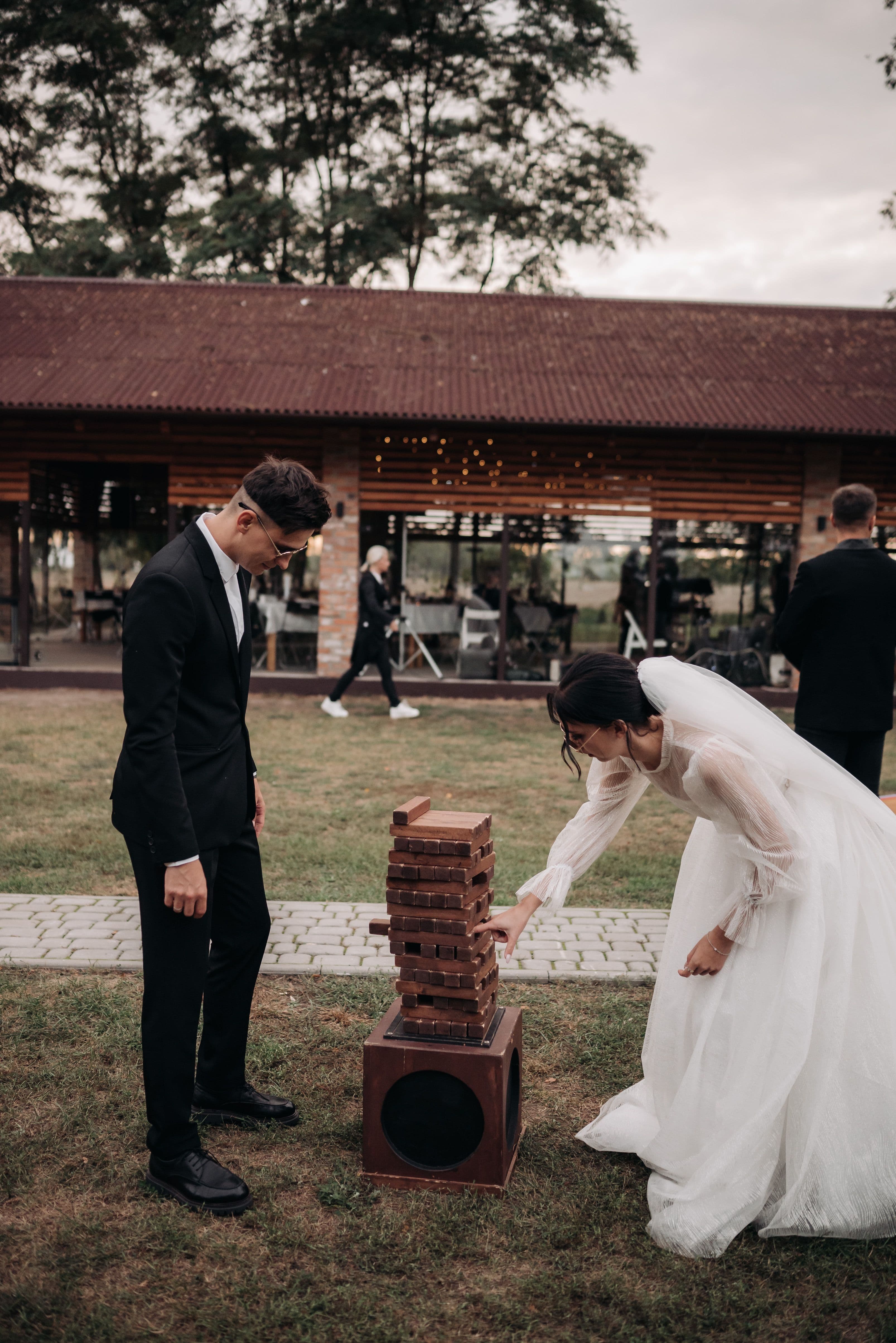 Bride and groom playing giant Jenga at their wedding reception